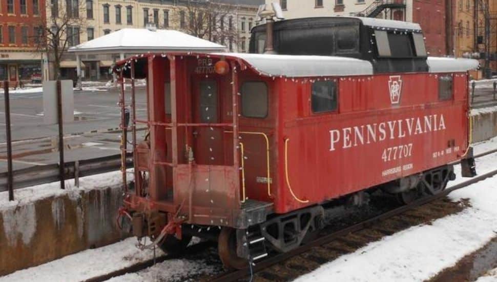 Small caboose with snow on it.