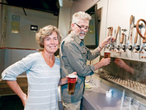 Jossy and Marc Osbourne, founders at Kennett Brewing Company, a new brewpub.—Photo via Steven M. Falk, Staff photographer at Philly.com