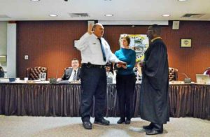 Gary Alderman with wife Wendie by his side as Judge Gregory Hines swears in the new Fire Chief.--via Lucas Rodgers, Daily Local News.