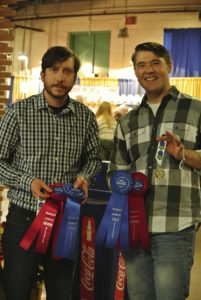 Matthew Hettlinger and Samuel Kennedy (right) of The Farm at Doe Run show off their ribbons for cheese production.
