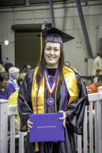 DCCC graduate Katie Thompson shows off her diploma.