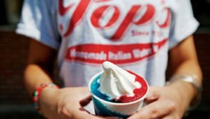 A Pop's Water Ice employee holds a gelati.