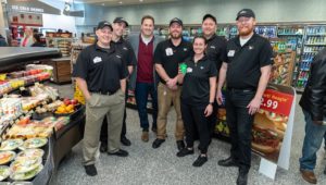 Signing bonuses are an incentive to bring new workers to Wawa's stores, like those pictured in this Wawa worker group shot.