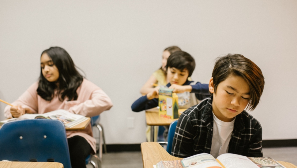 Students reading text books in a class overseen by a Lincoln Center behavior specialist.