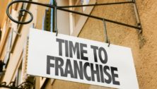 A exterior store sign that says "Time to Franchise."