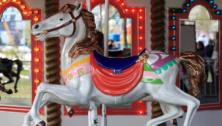 A colorful house on a carousel.