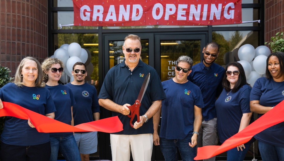 Members of The Lincoln Center cut the ribbon at the entrance to their new building.