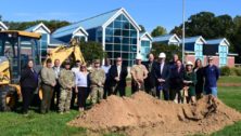 A group of people participating in a ground breaking ceremony for a new athletic facility at Valley Forge Military Academy.