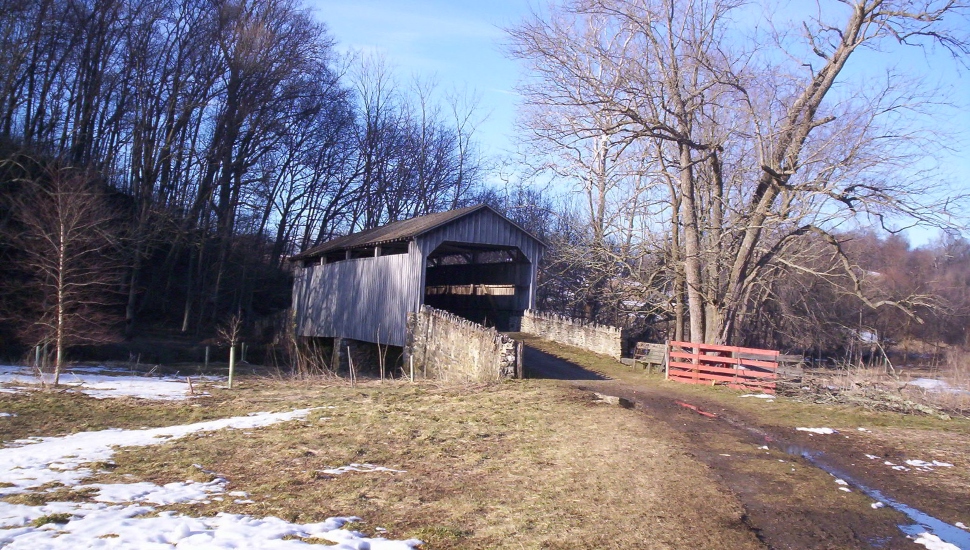 covered bridge in a field