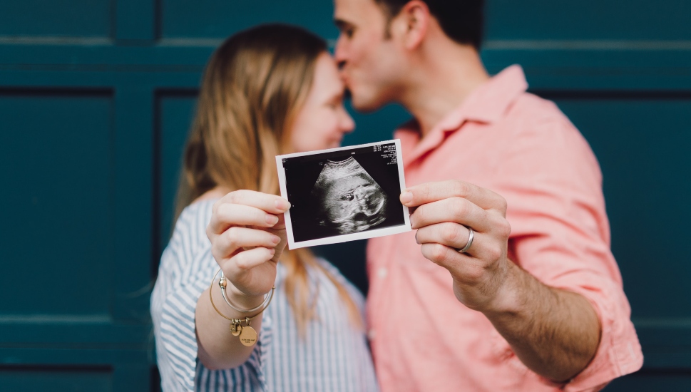 man and woman with ultrasound photo