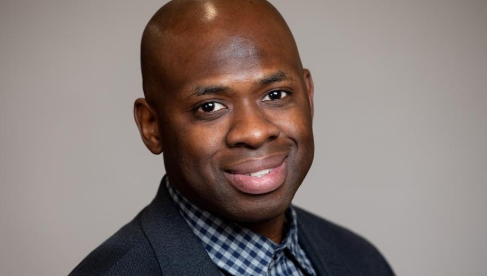 man in checkered shirt and blue jacket