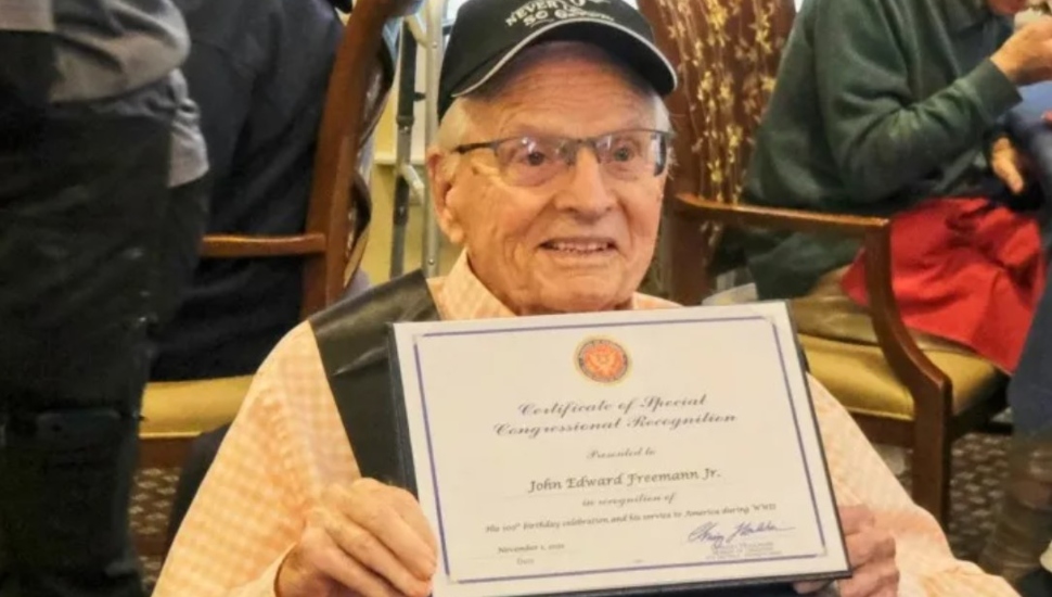 man in hat with certificate