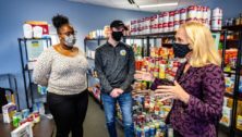 Neumann University students Erin Williams and David Shertel meet with US Congresswoman Mary Gay Scanlon at Knight's Pantry.