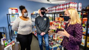 Neumann University students Erin Williams and David Shertel meet with US Congresswoman Mary Gay Scanlon at Knight's Pantry.