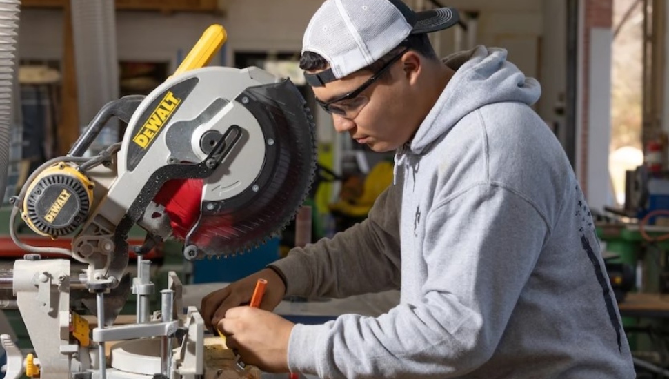 Carpentry student Jose Santos Jr. takes measurements.