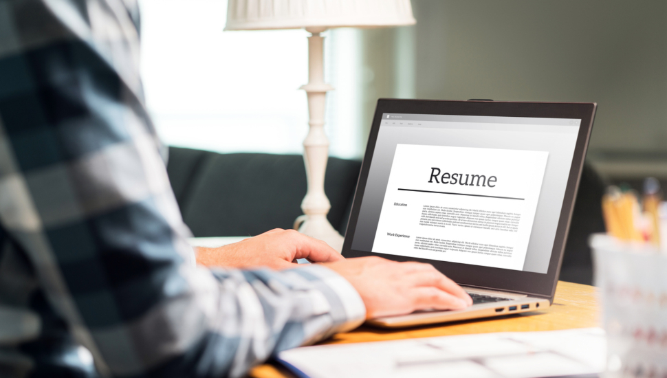 Man editing his resume on a laptop