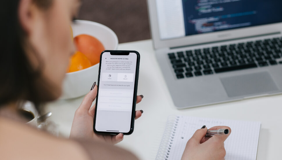 Woman using cell phone at her desk