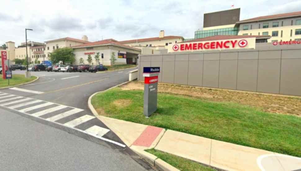 driveway into building with sign