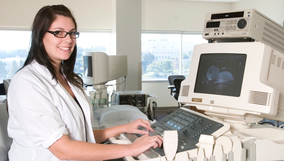 A sonographer looking at a sonogram.