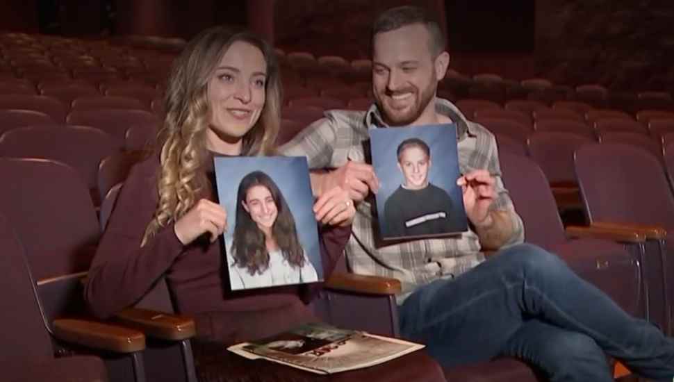 couple holding pictures