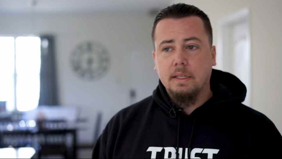 man with goatee in hoodie