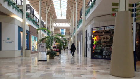 A woman walks through an empty Exton Square Mall