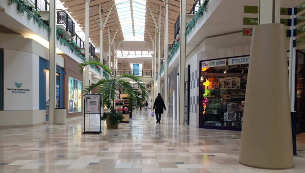 A woman walks through an empty Exton Square Mall