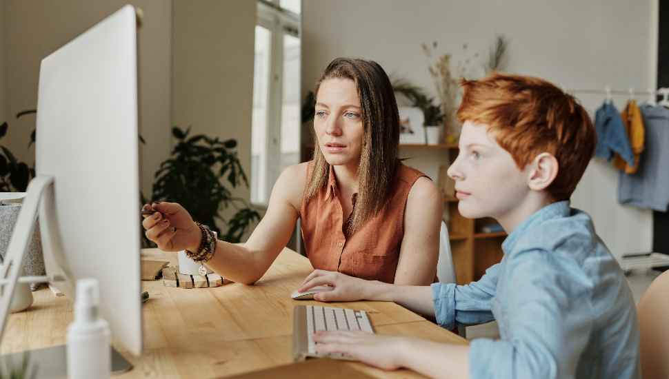 woman and boy at monitor