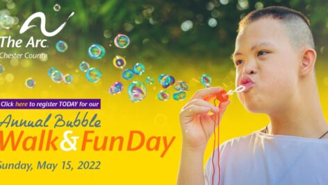 A young boy blowing bubbles as a promotion for the Bubble Walk and Fun Day.