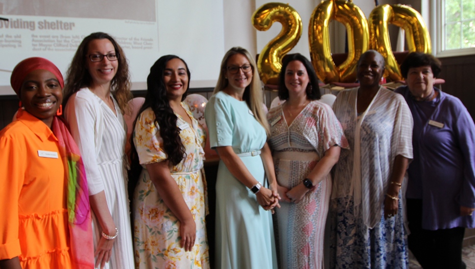 A group of women gathered at a 200th anniversary celebration of the Friends Association