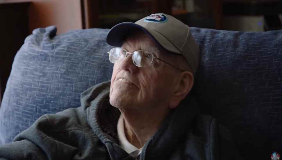 man in chair wearing hat