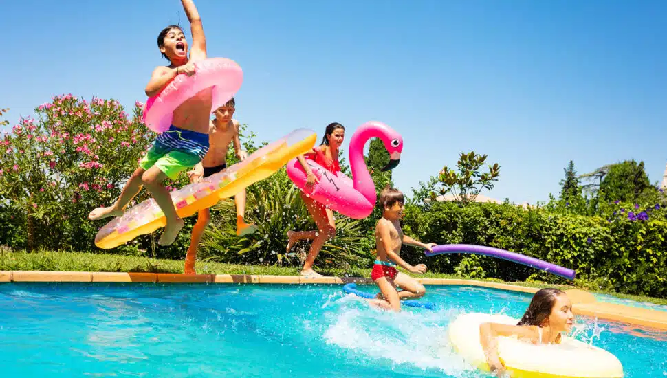 kids jumping into pool