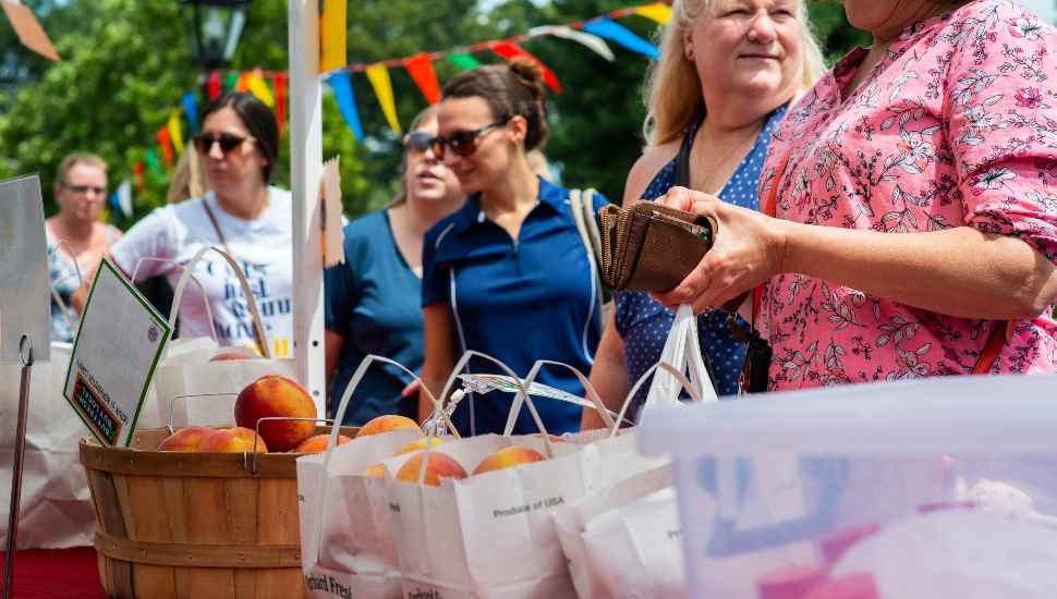 women buying fruit Peach Month