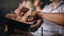 people eating popcorn while watching a film