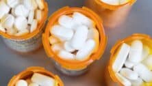 white pills in orange medication bottles