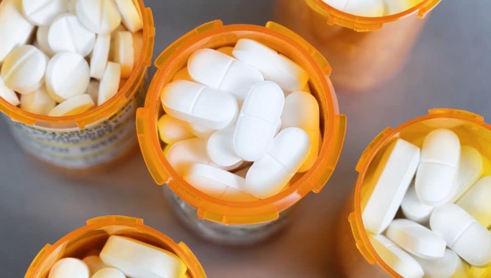 white pills in orange medication bottles