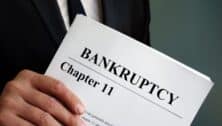 man holds papers about Chapter 11 Bankruptcy