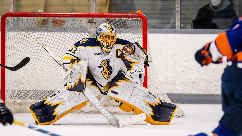 Neumann University ice hockey goalie Kyle Pantalone guarding the net during a game.