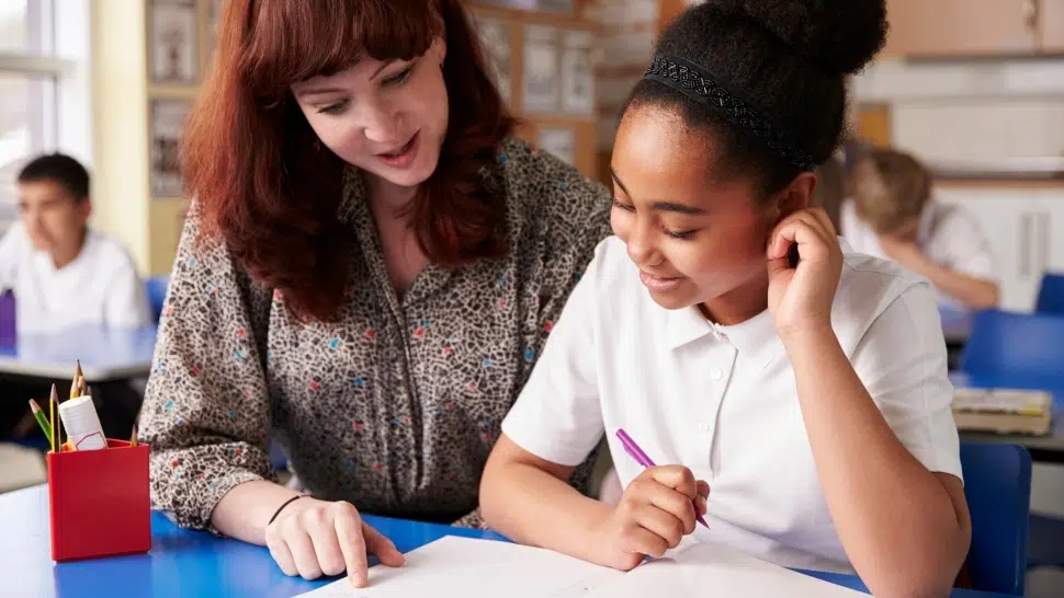 A teacher works with a student. The Lincoln Center for Family and Youth is looking to fill 3 special education positions.