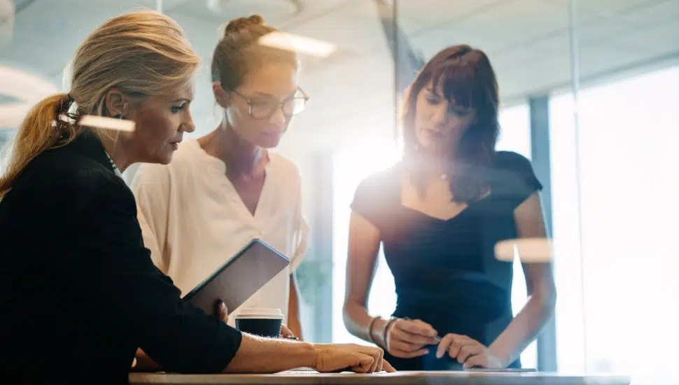 three women in office working