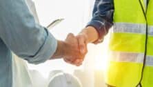 construction man and businessman shaking hands