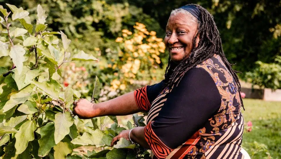woman smiles while gardening