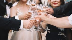 people clinking glasses at wedding