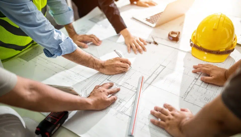 engineers drawing up construction plans