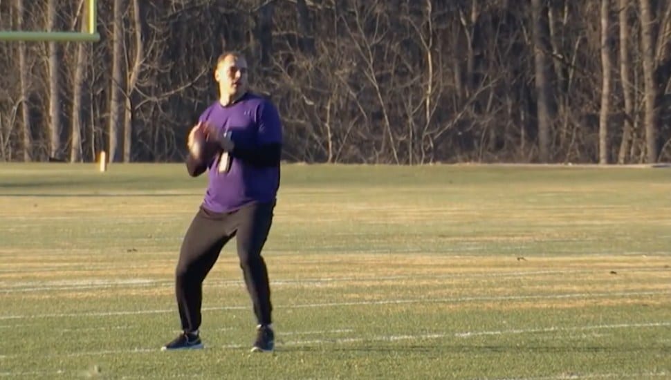 man in purple jersey with ball