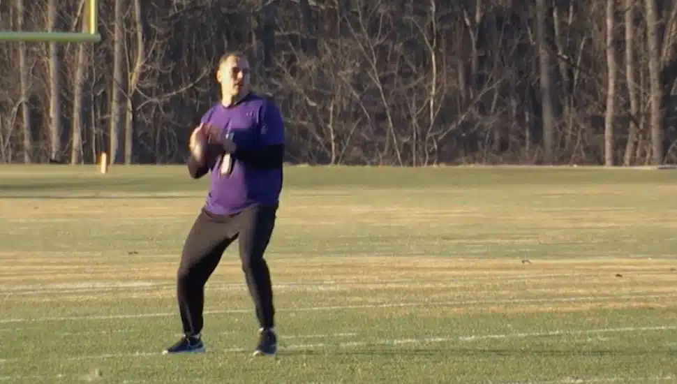 man in purple jersey with ball