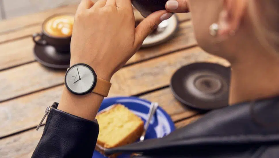woman wearing watch, drinking coffee