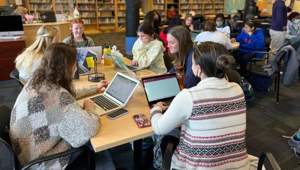 students in school library working