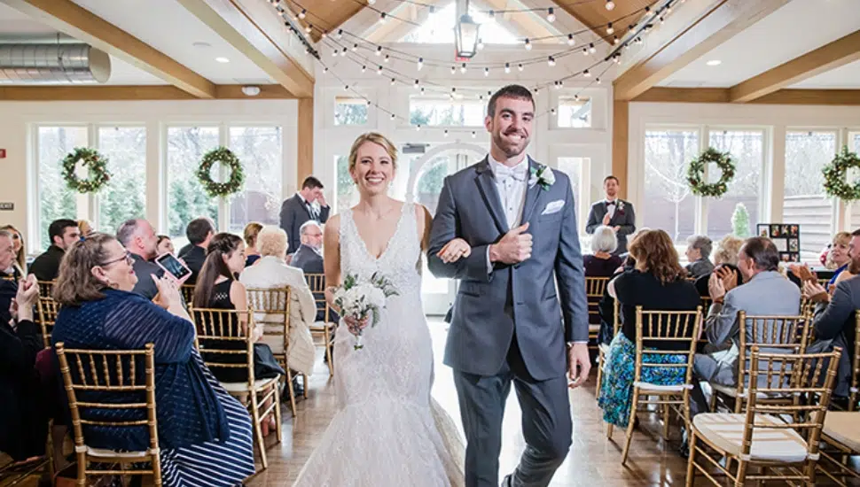 farmhouse wedding couple walks down aisle
