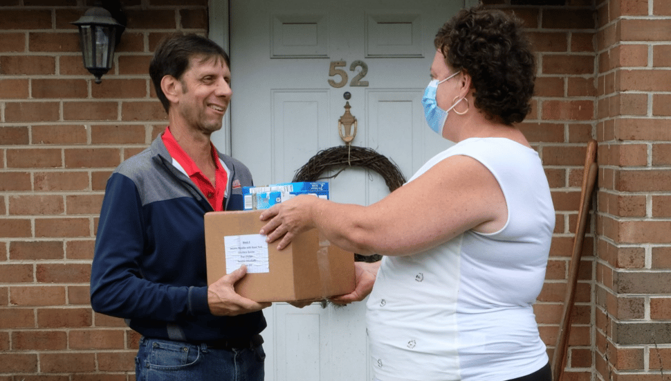 woman giving a good donation for hunger action month